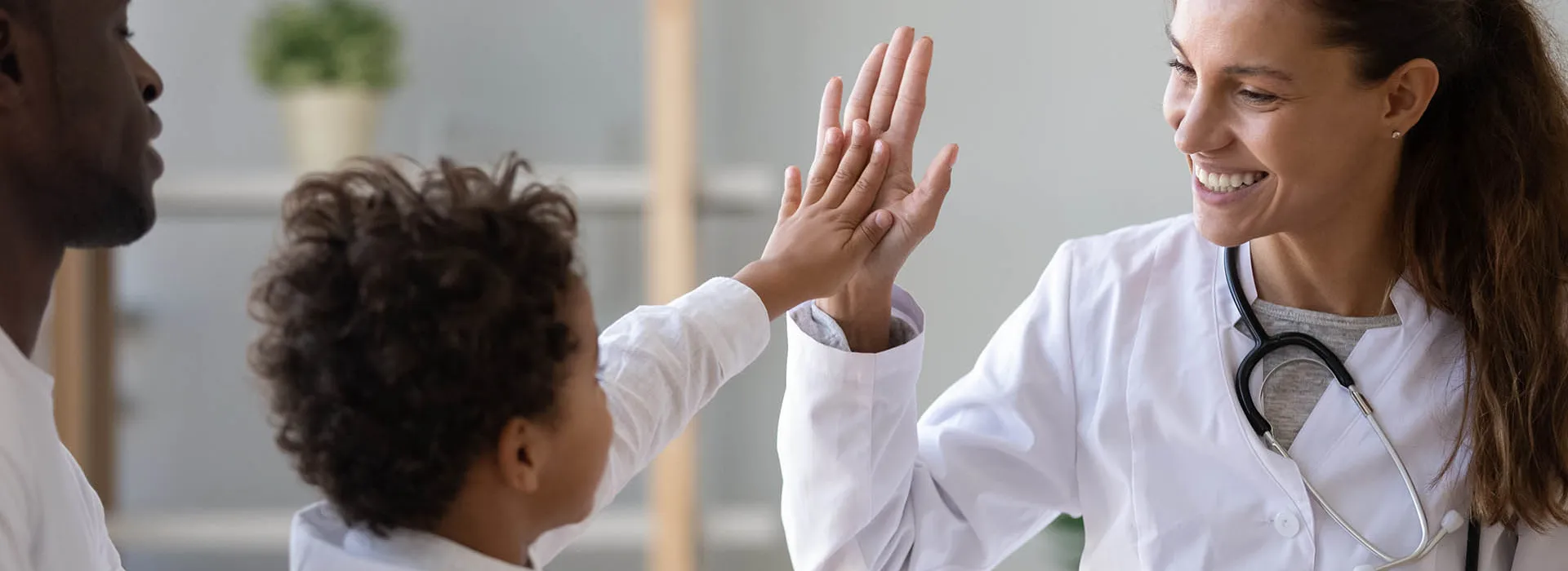 high five between doctor and child 