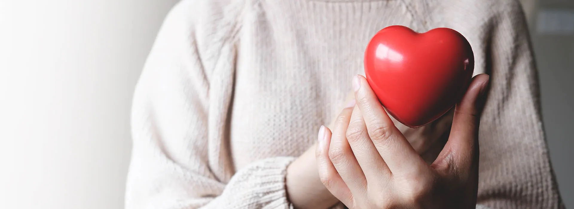 woman holding red heart