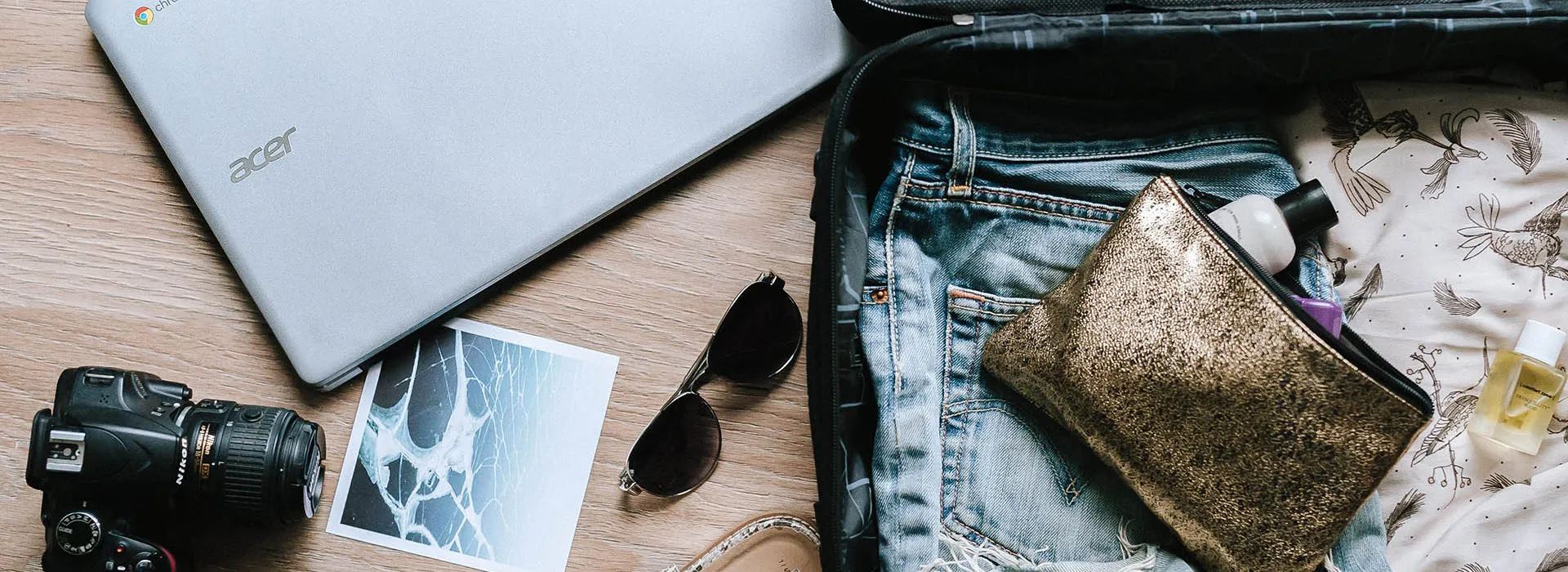 small suitcase sunglasses laptop camera