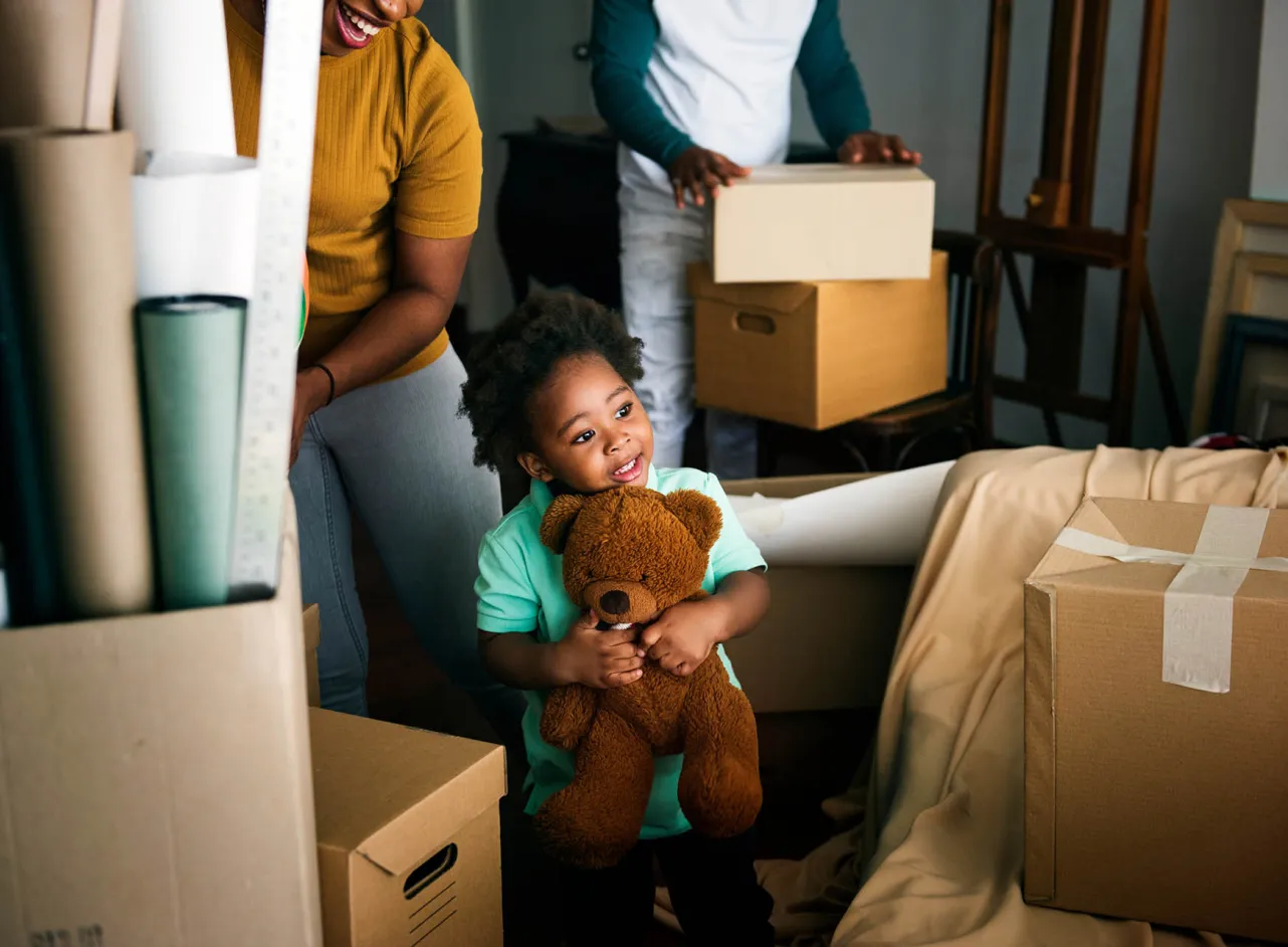 child and teddybear during moving house 