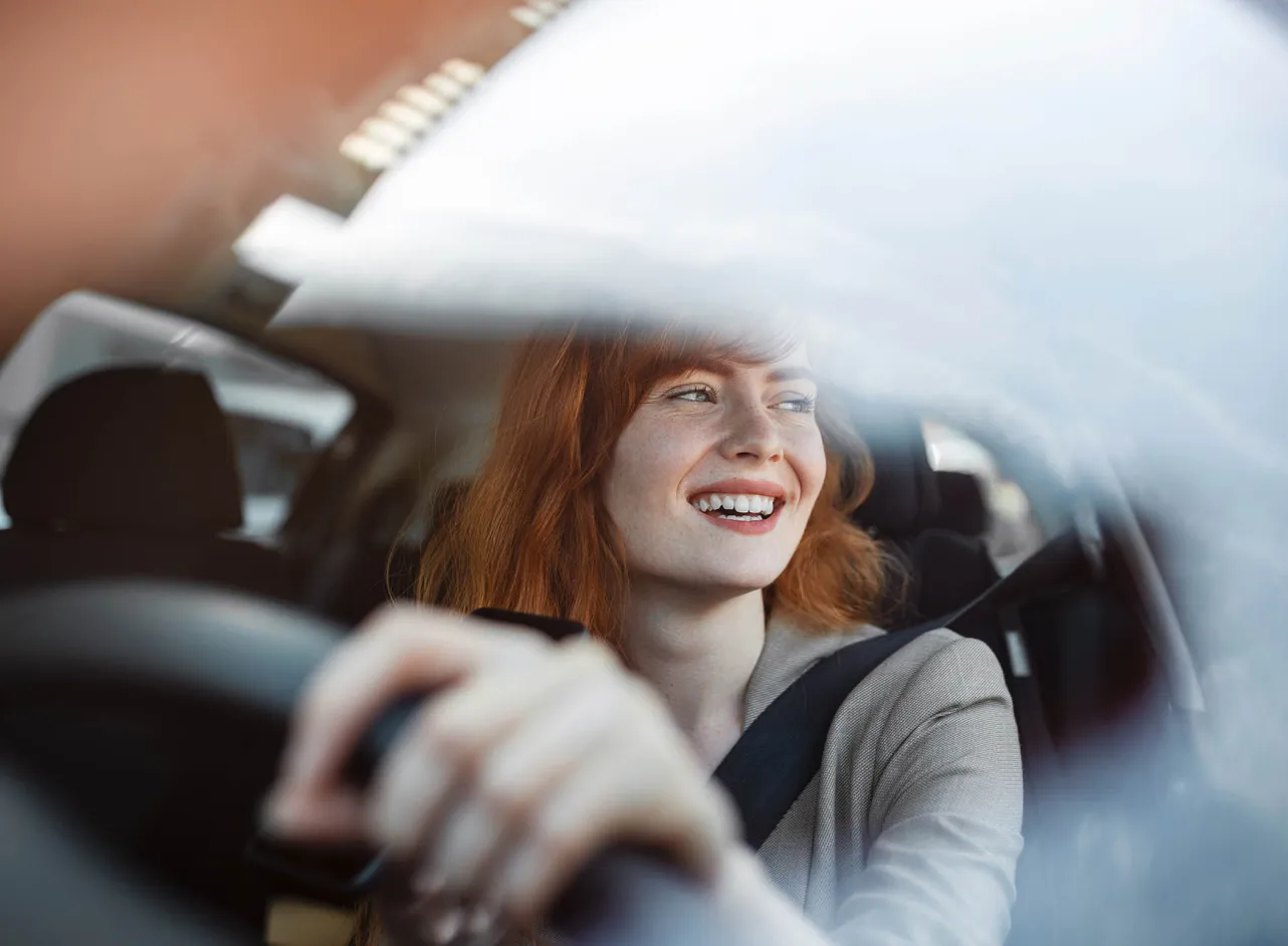 redheaded woman driving 